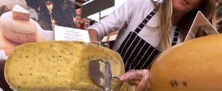 wheel of cheese being cut in Piedmont