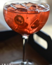 Aperol Spritz drink, served in a class bright red color iced and orange slices