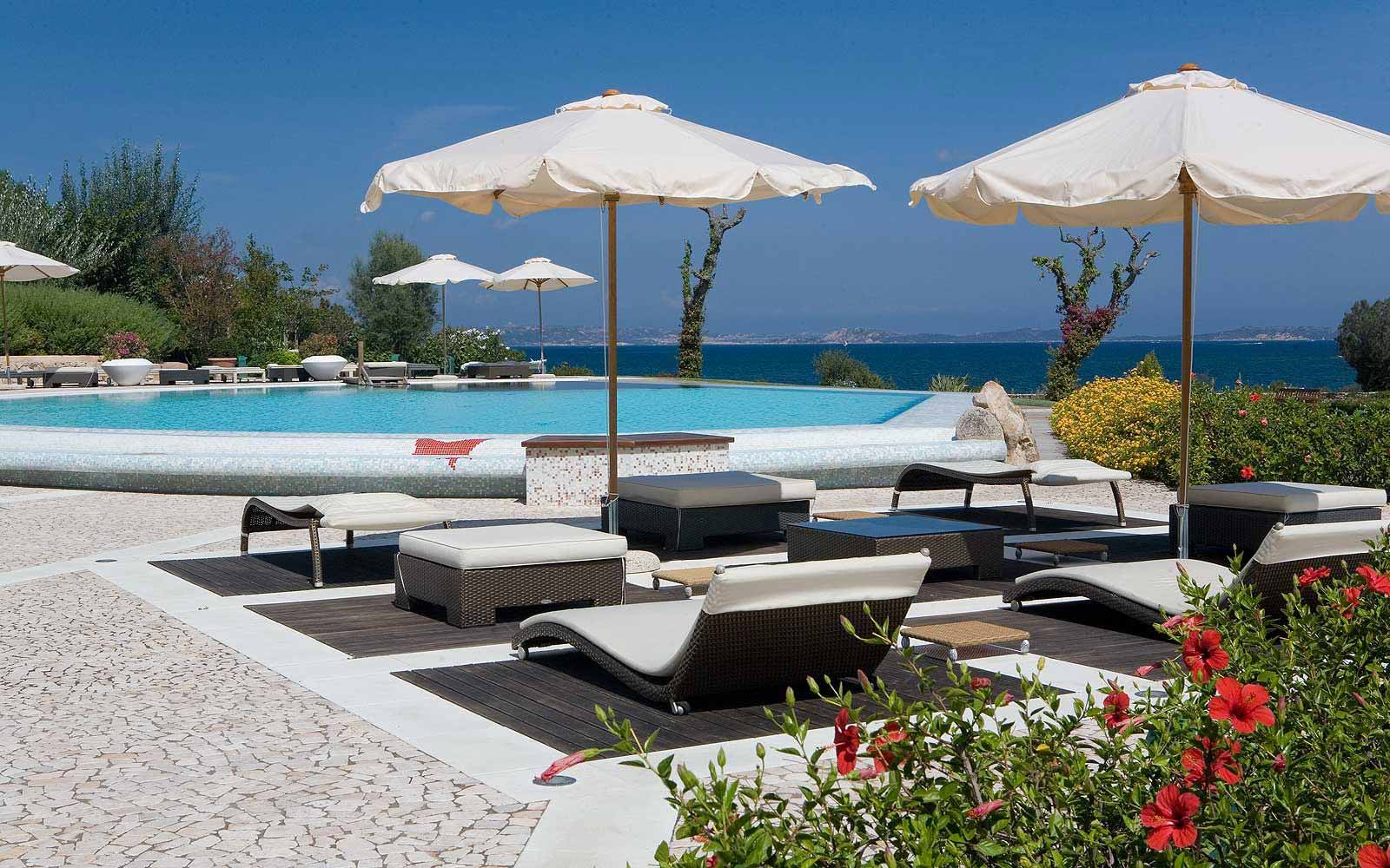 Sunbeds by the pool at L'Ea Bianca Luxury Resort