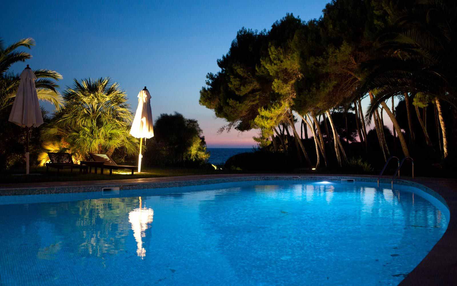 Swimming pool at night Hotel Cala Caterina